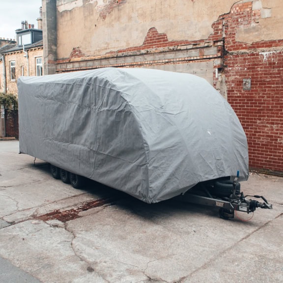A Brian James Trailer with a bespoke fit outdoor cover in grey.