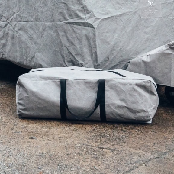 A picture of a grey Caravan Upgraded Storage bag with black zips and handles.