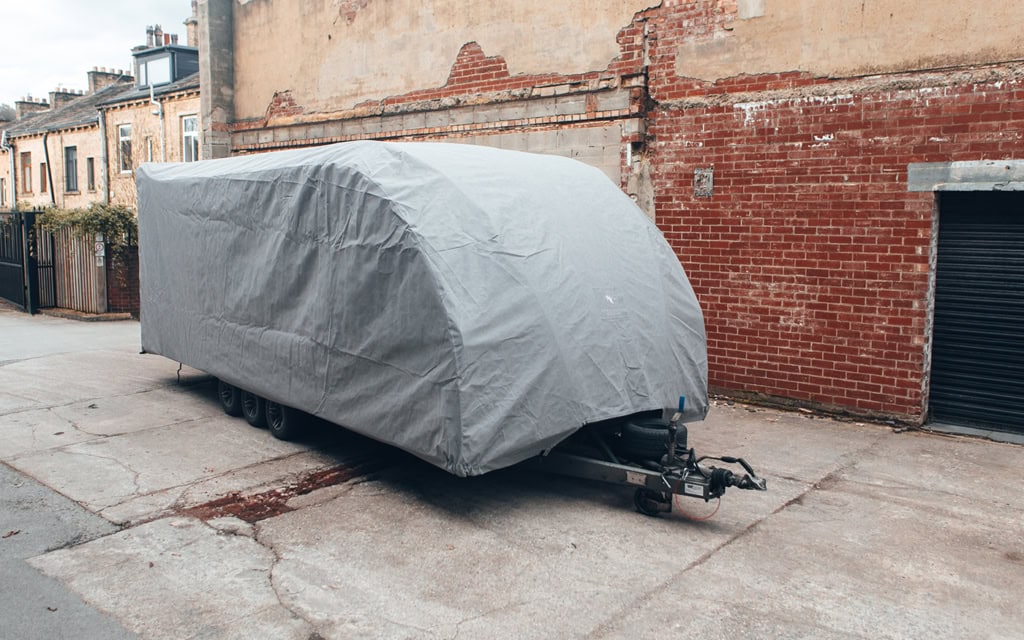 A Brian James Trailer with a bespoke fit outdoor cover in grey.