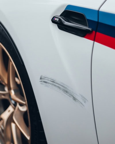 An image of a scratch mark on a BMW which could have been protected by a car cover.