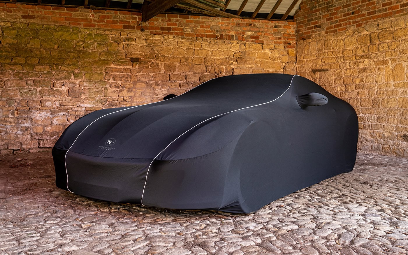 High-quality black indoor car cover for garage storage, offering protection against dust, dirt, and scratches for vehicle preservation. Custom-fit to ensure a snug, secure fit for indoor use.