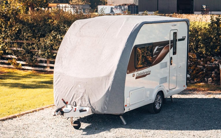 A protective caravan cover designed for outdoor use, ensuring full coverage and weather resistance for your caravan. Keeps your caravan safe from dirt, rain, and UV damage during storage.
