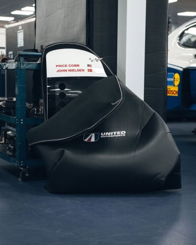 Innovative bespoke race car cover for motorsport vehicles, ensuring maximum protection and durability. Custom-fit design for motorsport teams, fabricated with high-quality materials for long-lasting usage.