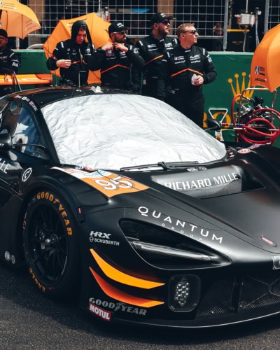 Stylish and durable racing car cover with reflective top layer for high-performance motorsport cars.