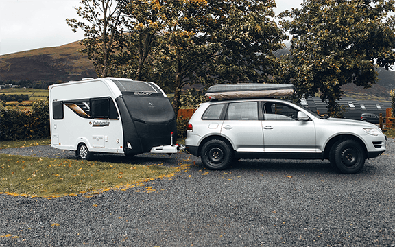 Durable towing cover protects vehicles and caravans from weather, scratches, and minor damages during transport and storage.