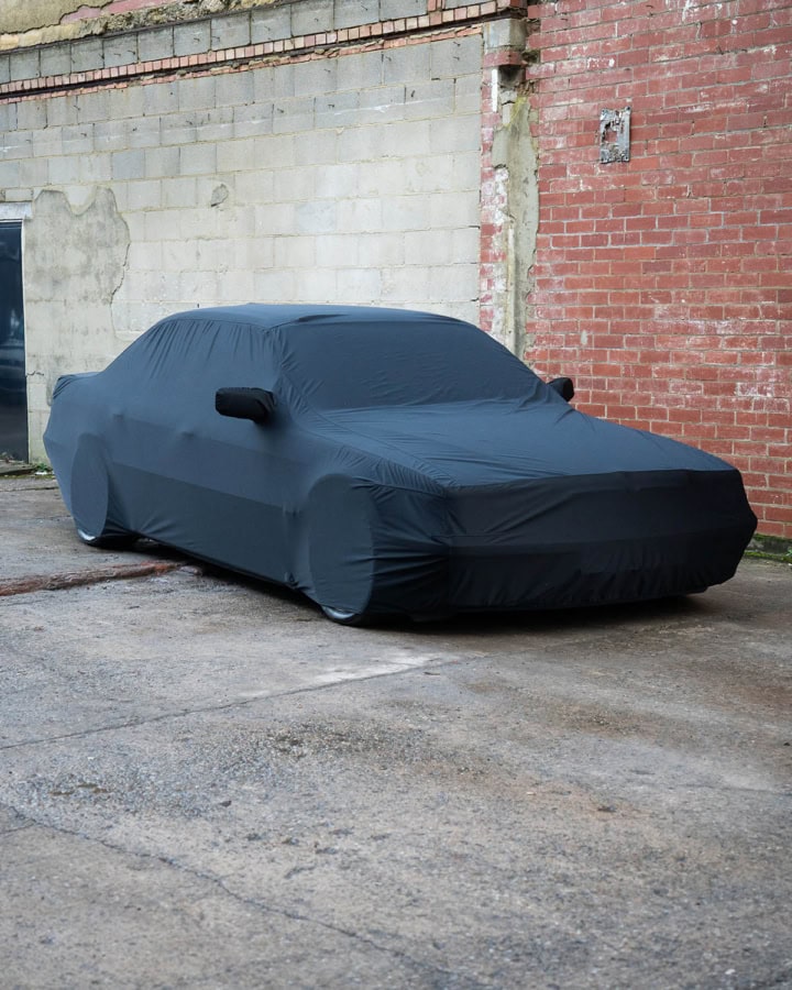 1. Custom car cover made from durable material, protects vehicles from weather, dust, and scratches for long-term outdoor storage.