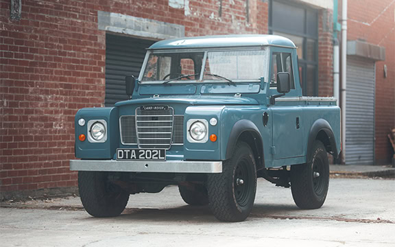 Heavy-duty vehicle cover custom fit for vintage Land Rover Defender, offering weatherproof protection and durability from specialised covers. Perfect for outdoor vehicle storage.