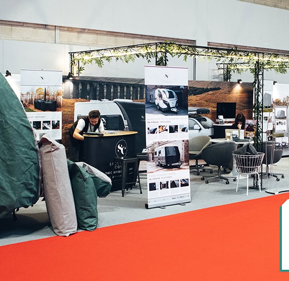 Exhibition of motorhomes and caravans at the 2026 show, showcasing specialised covers and accessories for caravans and motorhomes.