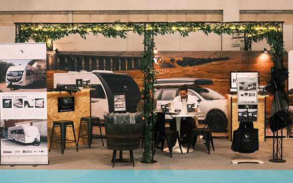 Exhibition booth showcasing specialised covers for motorhomes and caravans at the 2026 Motorhome & Caravan Show, with promotional displays and staff.