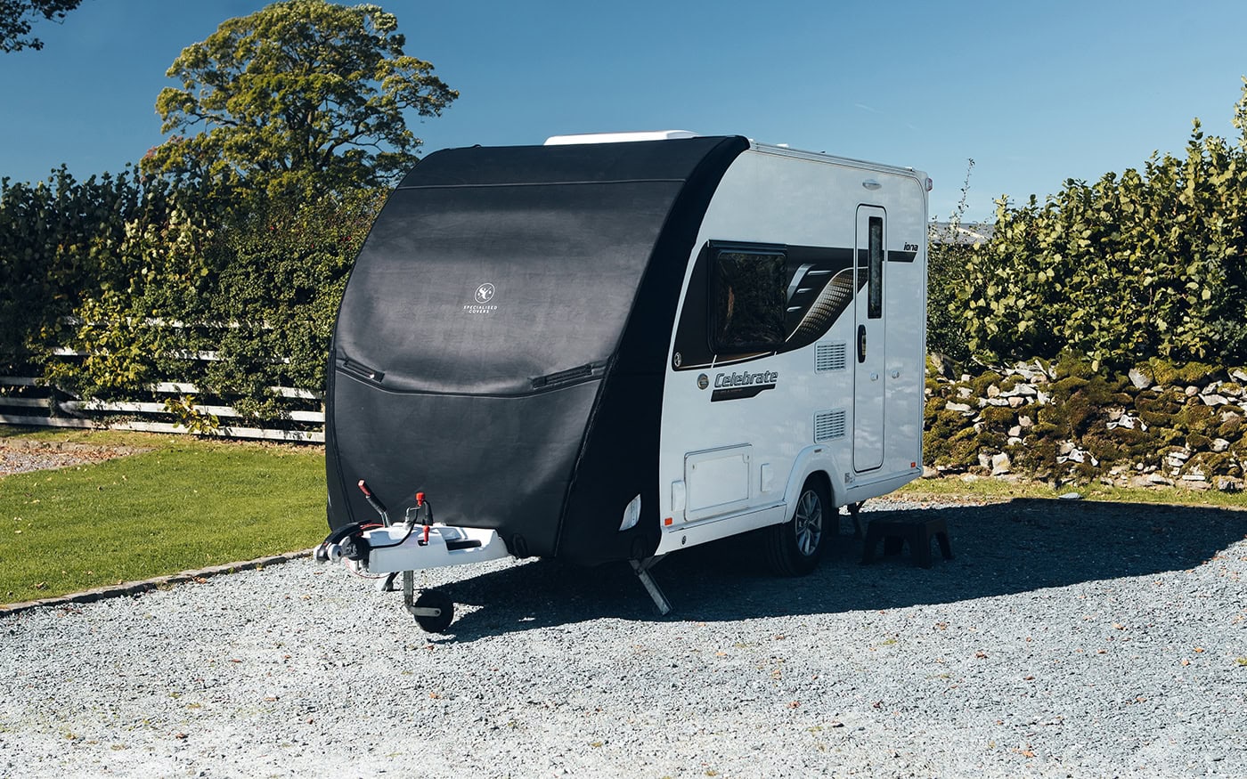 High-quality tailored cover for a travel trailer to protect against weather and UV damage. Custom fit for enhanced durability and a secure fit. Suitable for all weather conditions.
