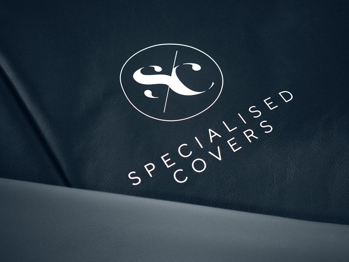 Durable, weatherproof trailer cover with specialised protection from Specialised Covers featuring logo print for secure transport.