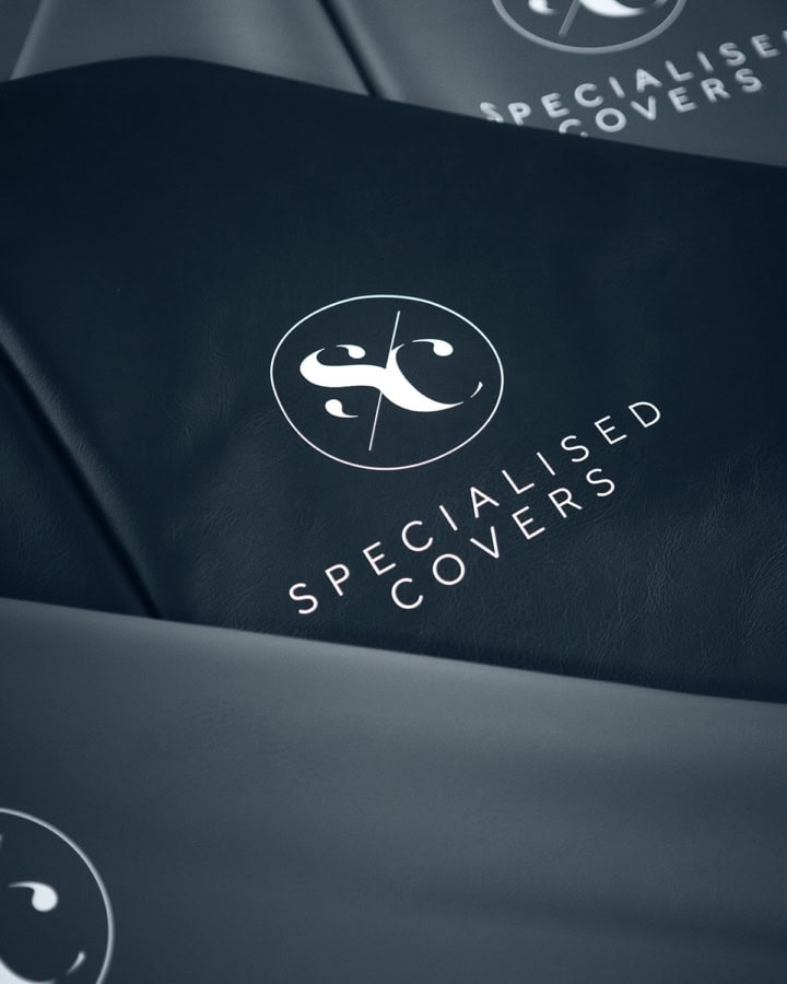 Durable, weatherproof trailer cover with specialised protection from Specialised Covers featuring logo print for secure transport.