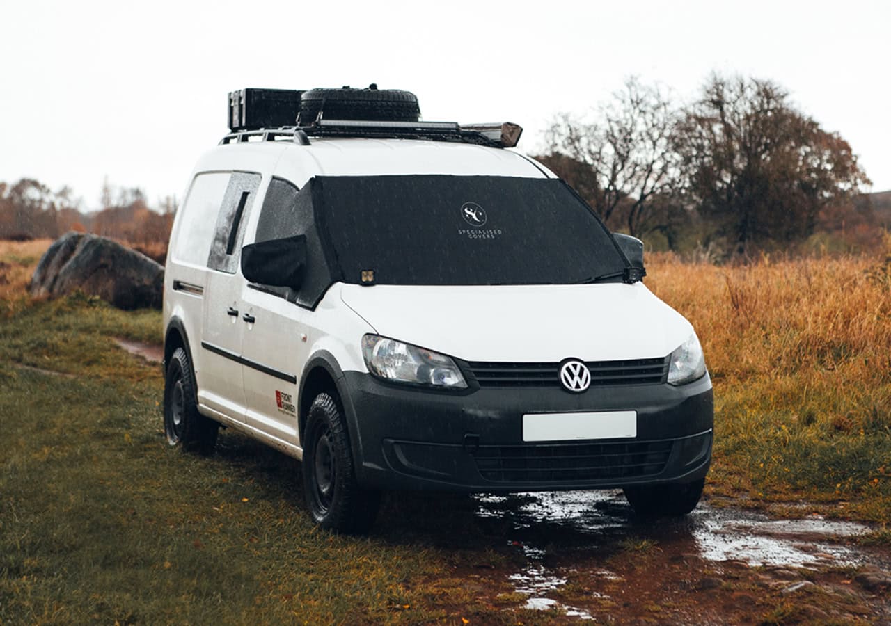 Weatherproof windscreen cover designed for campervans to protect against rain, frost, and UV rays. Easy to install and durable, ensuring clear visibility and vehicle protection.