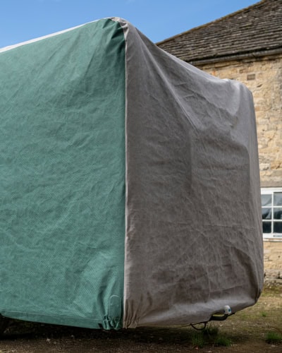 The rear of a Motorhome with a cover on, with extra allowance for a bike rack.