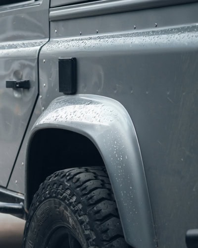 An image of car bodywork with morning dew water drops on it.