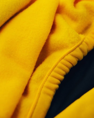 A picture of the Prestige Plus material in yellow with the fleece lining.