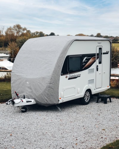 A caravan on a storage site with a bespoke fit Roof Cover.
