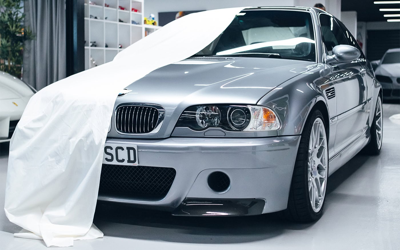 A picture of a pinned cloth to tailor a pattern for a BMW cover.