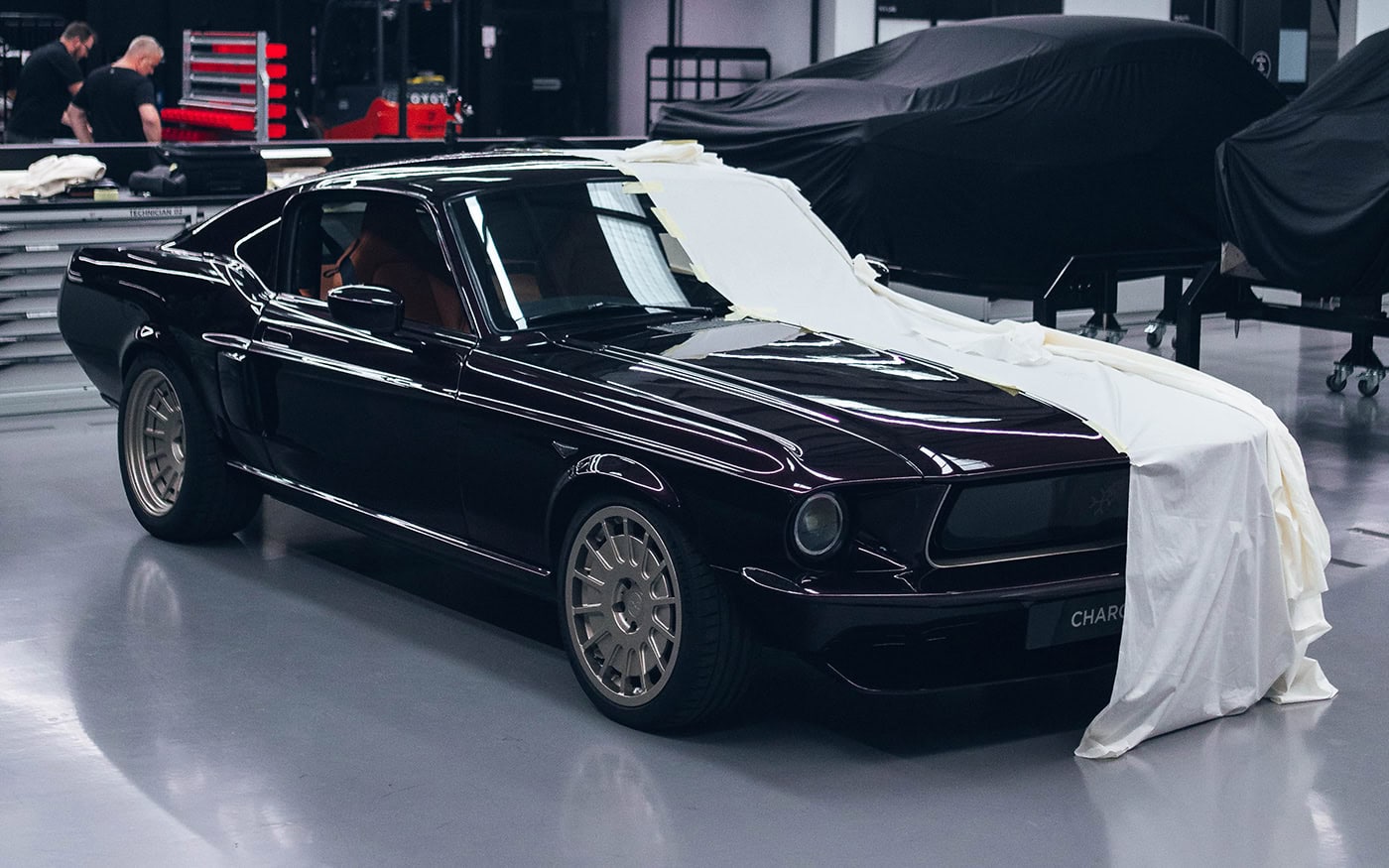 A picture of a designer tailoring cloth for a car cover pattern.