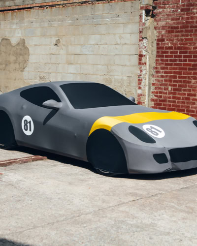 A Ferrari 599 with a Indoor Silhouette Car Cover on finished with a racing livery.