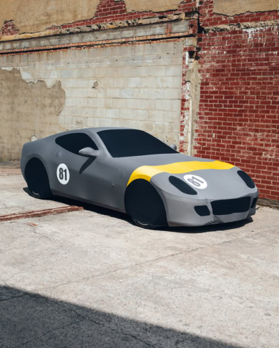 1. Custom car cover designed for racing cars, with grey and yellow accents, featuring the number 81 on the hood and side, suitable for outdoor protection.