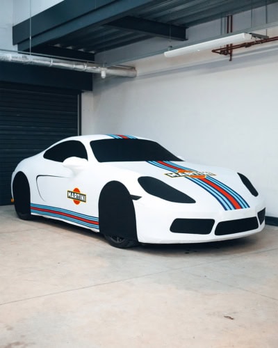 Protective custom car cover featuring Martini racing stripes and logo, designed for classic and sports cars, offers excellent weather resistance and full vehicle coverage.