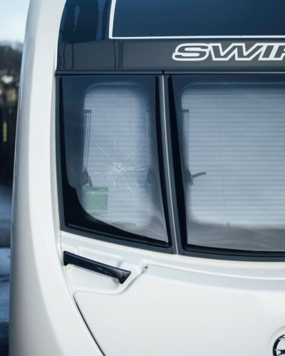 An image to show the stone chip damage to a front window when unprotected.