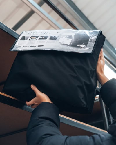 Heavy-duty towing cover for vehicles, fitted with tailored protection to prevent damage and debris accumulation. Durable, weather-resistant material enhances vehicle safety during transportation.