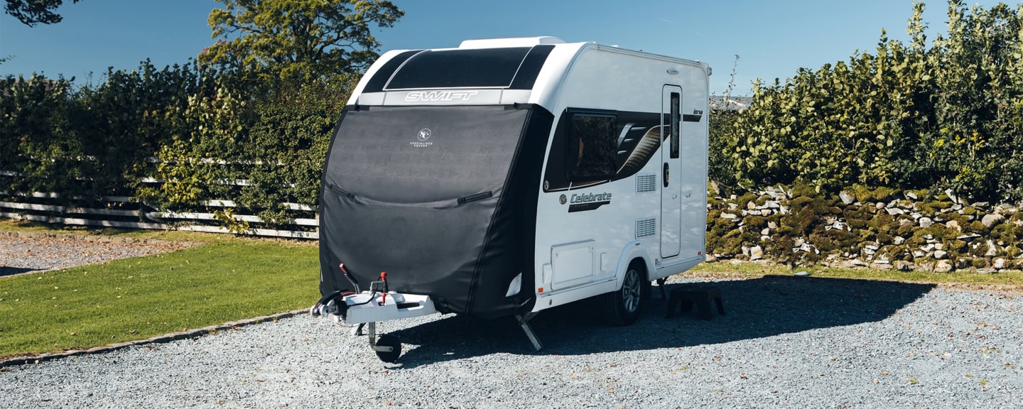Durable black towing cover for caravans, trailers, and motorhomes, providing protection from weather and debris. Custom-fit design ensures a snug, secure fit for all towing accessories.