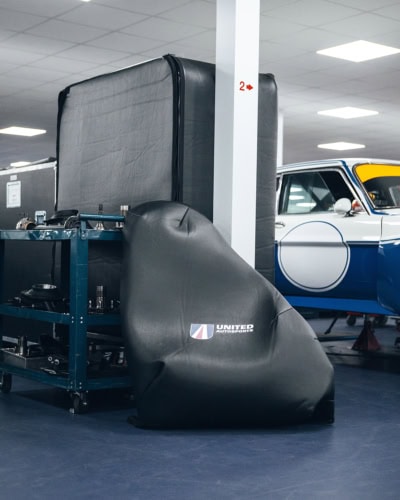 Durable black custom car cover from Specialised Covers, designed for excellent vehicle protection and outdoor use. Perfect for garages, racetracks, and automotive storage solutions.