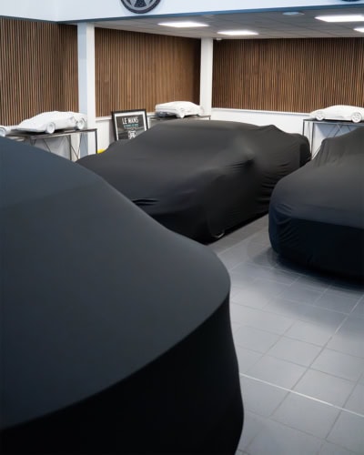 Extensive range of custom vehicle covers, including tailored fabric options to ensure optimal protection against weather, dust, and scratches for all car types.