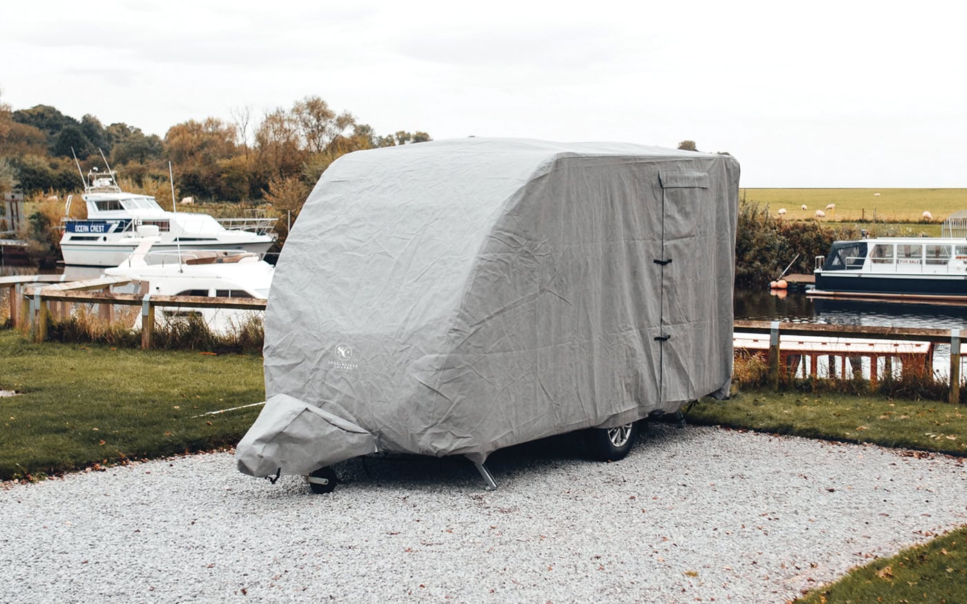 Durable woven polyester caravan cover for outdoor protection against weather elements. Custom-fit, waterproof, UV resistant and easy to install for long-lasting storage.