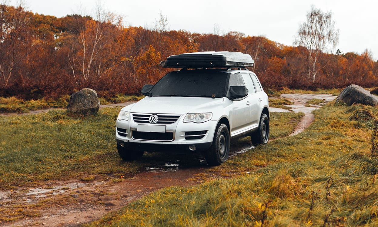 Heavy-duty vehicle cover protects VW SUV from weather elements. Durable outdoor car covers ideal for outdoor adventures. Perfect for off-road trips and outdoor storage.