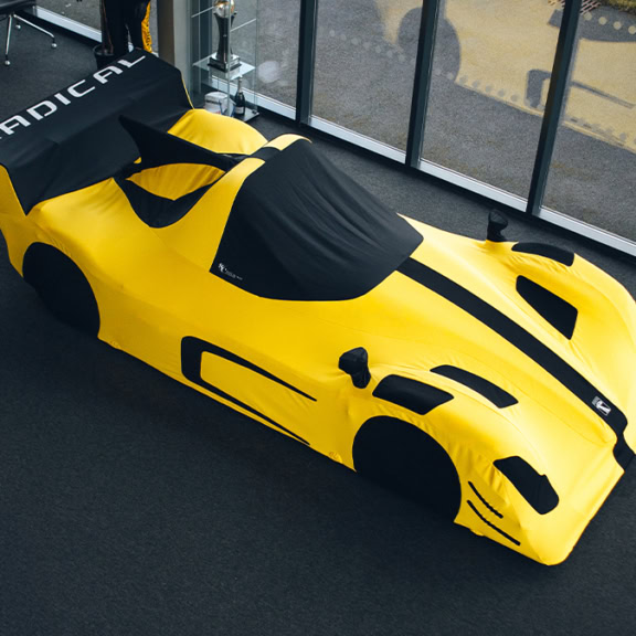 High-quality bespoke car cover designed to fit a racing car, providing maximum protection during Radial Owners Track Day events. Customisable, durable, and weather-resistant for optimal vehicle safety.