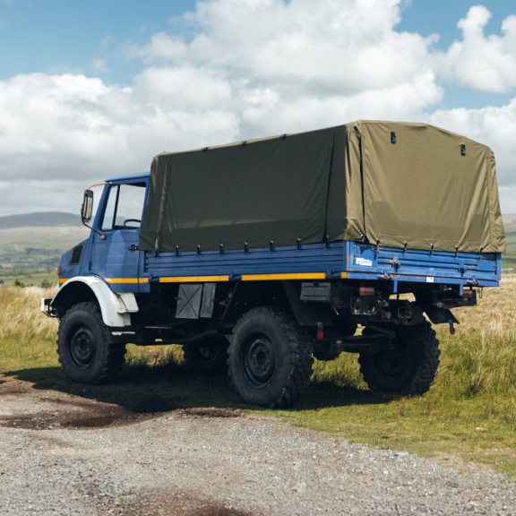 Durable, custom-made Unimog cover for Atkinson Vos trucks, designed for maximum protection and weather resistance against outdoor elements in rugged terrains.