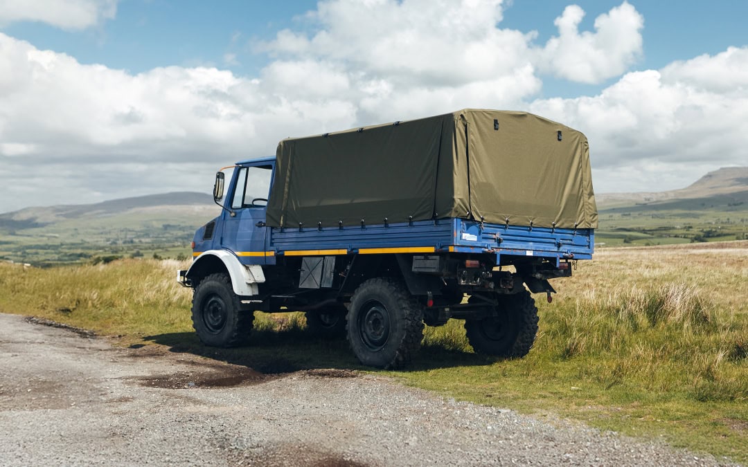 Durable, custom-made Unimog cover for Atkinson Vos trucks, designed for maximum protection and weather resistance against outdoor elements in rugged terrains.