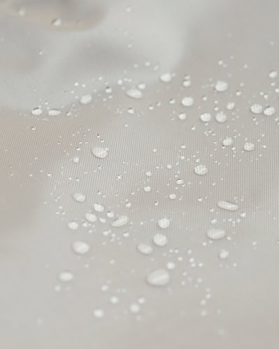 Water-resistant kitchen cover with water droplets showing its waterproof ability, ideal for protecting countertops and surfaces from spills and splashes.