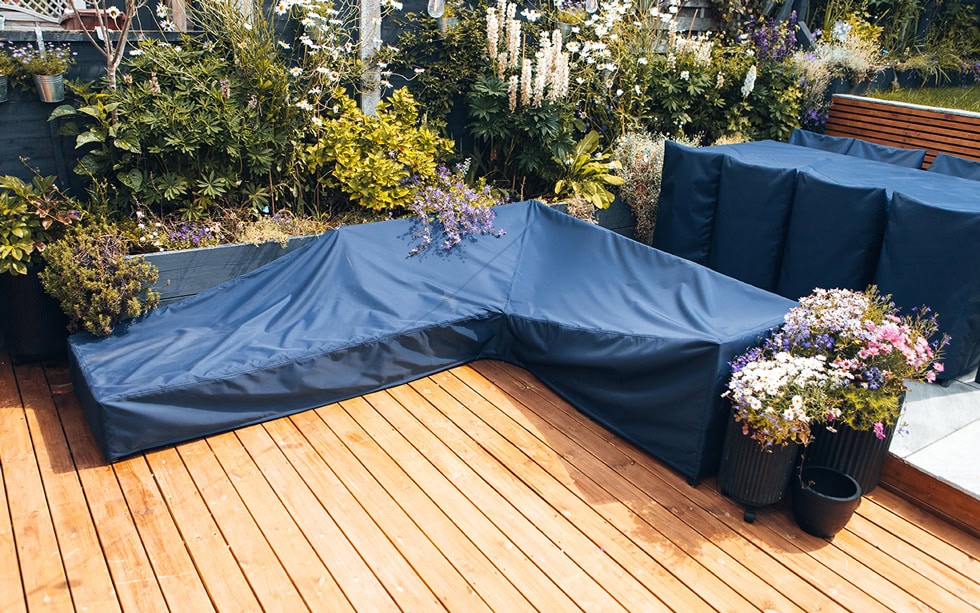 Protective garden furniture cover, waterproof and weather-resistant, designed for outdoor patio sets and sofas, made from durable material to safeguard against rain, UV rays, and dust.