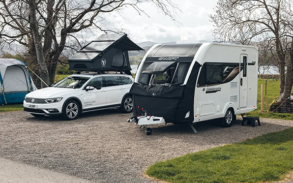 1. Custom caravan and vehicle covers by Specialised Covers, providing weatherproof protection for caravans and cars during camping trips and outdoor storage in the UK.