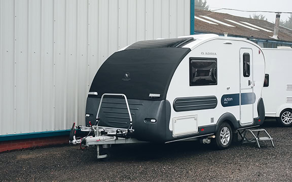 Durable all-weather travel trailer cover designed to protect caravans from rain, snow, and UV damage, ensuring longevity and maintaining appearance.