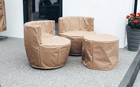 Protective covers for outdoor garden furniture, including chairs and ottomans, designed to shield against weather elements and keep your outdoor space looking pristine.