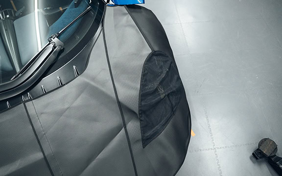 An image showcasing a durable, custom-fit body protection cover for motorsport vehicles, designed to shield against dirt, scratches, and environmental damage.