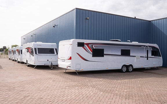 An image showcasing multiple custom-fitted caravan covers designed for European caravans, highlighting durability and weather protection.