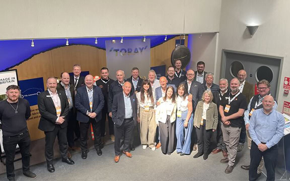 Group of professionals at a corporate event showcasing specialised covers for various industries, highlighting quality and innovation.
