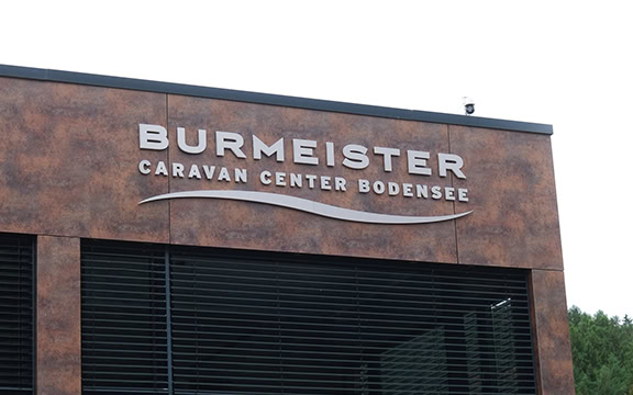 Exterior view of Burmeister Caravan Center Bodensee showcasing the building's signage and modern facade.