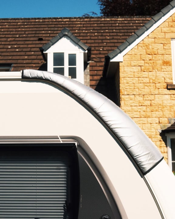 High-quality specialised covers installed on a modern window of a residential property, providing weather protection and insulation.