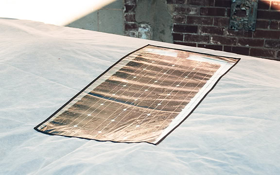 Caravan cover with integrated solar panel window, providing protection and solar energy collection for caravans.