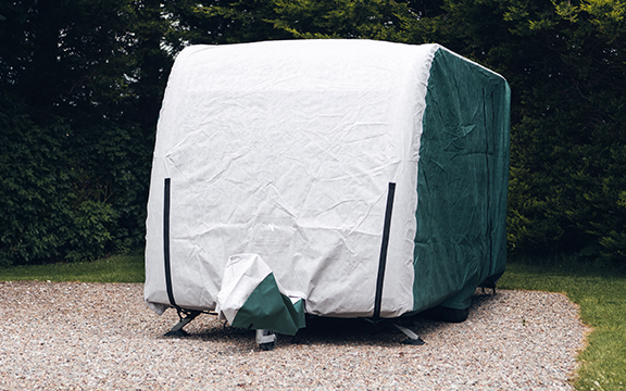 Protective winter storage cover for outdoor furniture or equipment, designed to withstand UK weather conditions.