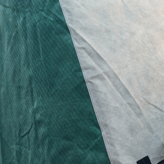 Close-up of a caravan storage cover showing durable fabric and stitching for protection against weather elements.